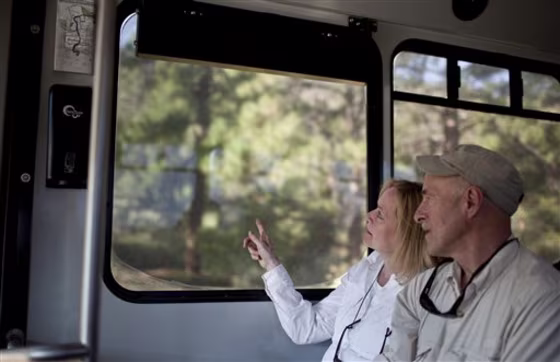Terry and Gary Steinhoff look out&nbsp;a shuttle window at&nbsp;Bandelier National Monument, N.M. After being closed because of the state's largest wildfire on June 27 and the threat of floods, the main archeological sites in Frijoles Canyon reopened Monday.